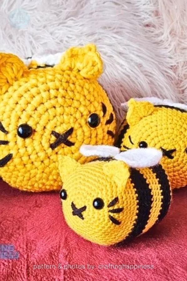 Three yellow and black striped amigurumi cats designed to look like bumblebees by Crafting Happiness; from a roundup on TheYarnCrew by Ariana Wimsett.